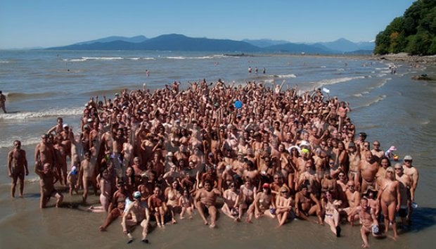 Two alluring women are relaxing on the nudist beach