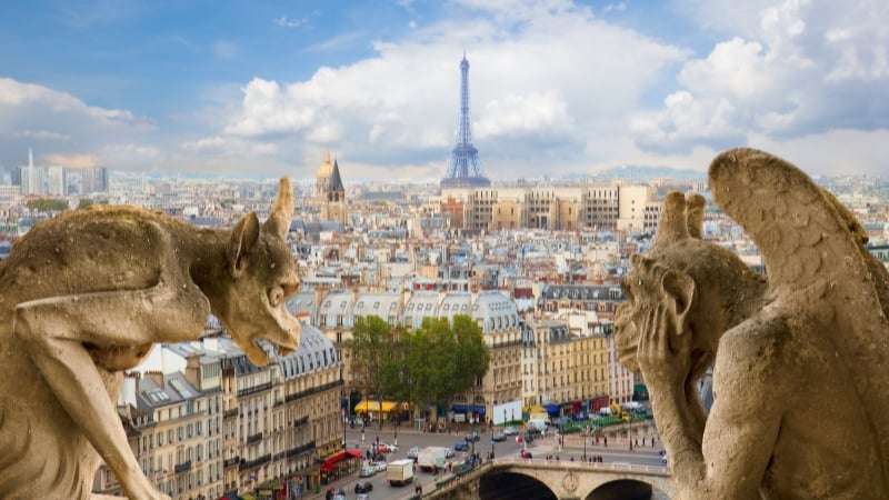 gargoyles on notre dame overlooking paris with the eiffel tower in the foreground