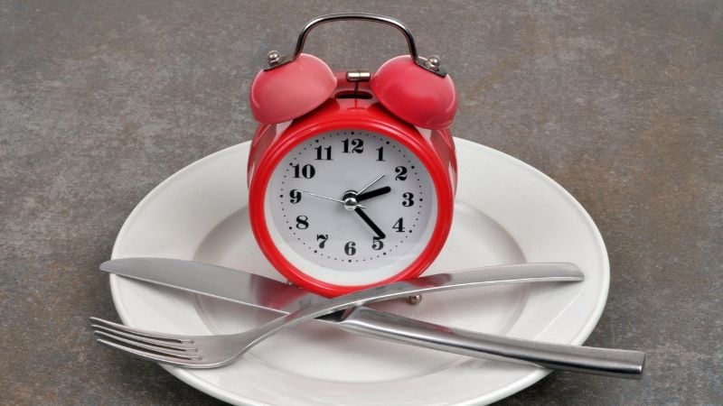 clock on a plate with cutlery