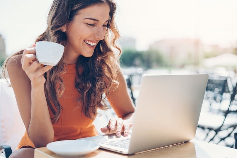 woman on her laptop with a cup of coffee