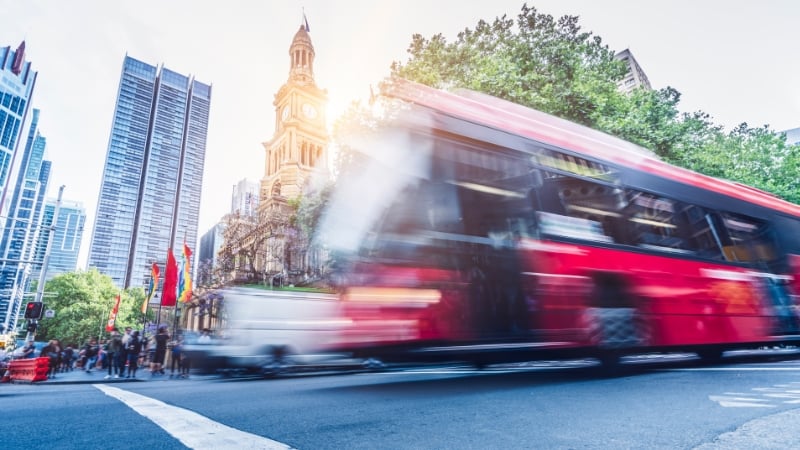 a bus zooming by in sydney's central business district