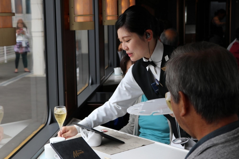 waitress serving glass of wine