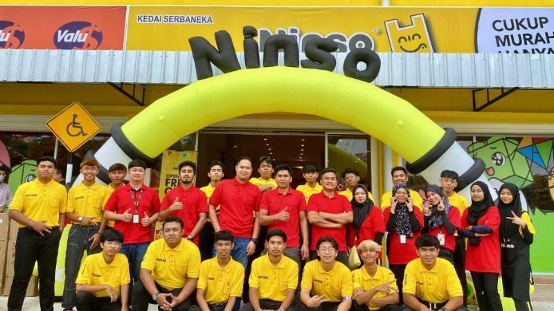 people posing in front of store