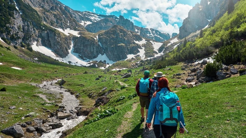 three people on a mountain adventure