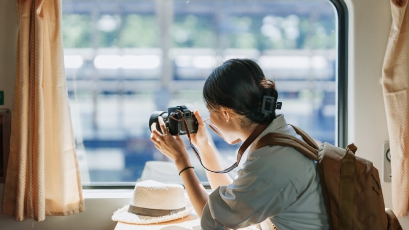 woman taking photo on the train