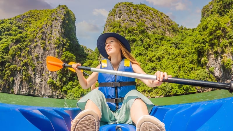 a woman kayaking in ha long bay