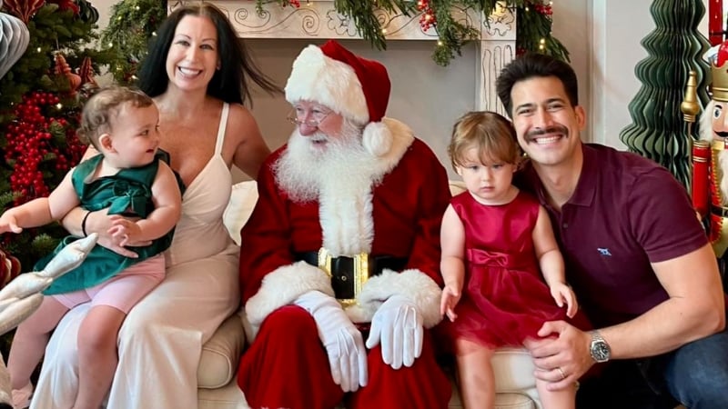 a family posing with santa at the cluny court christmas market