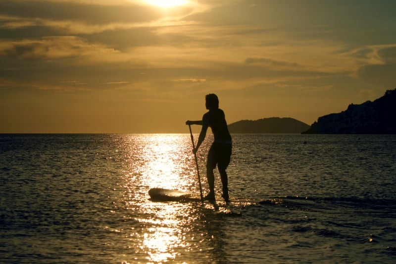 standup paddleboarding sunset