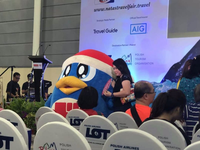 mascot photo-taking at natas travel fair