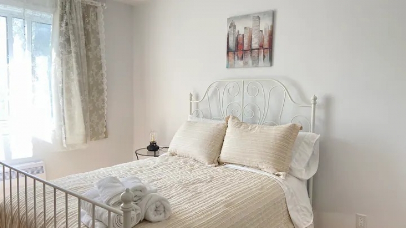 Bedroom of this Airbnb surrounded by greenery