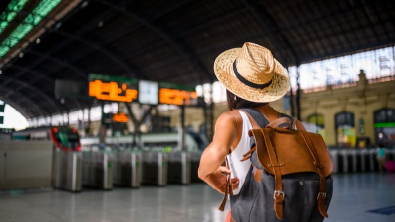 a woman on a solo travel adventure at the train station