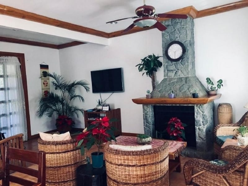 Fireplace in living room of Forest Log Cabin