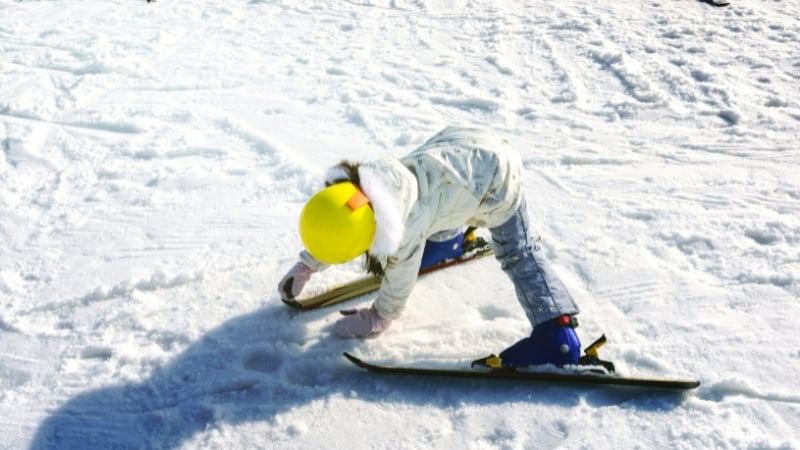 a skiier bending over